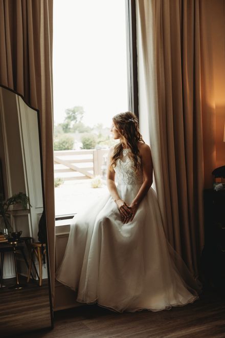 Bride by the bridal suite window
