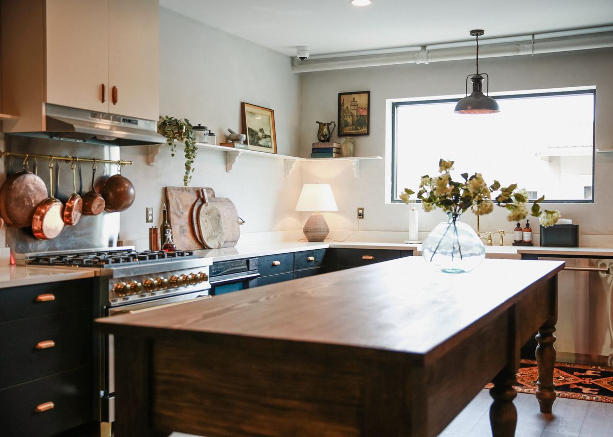 Caterer’s kitchen with a wooden island and copper pans