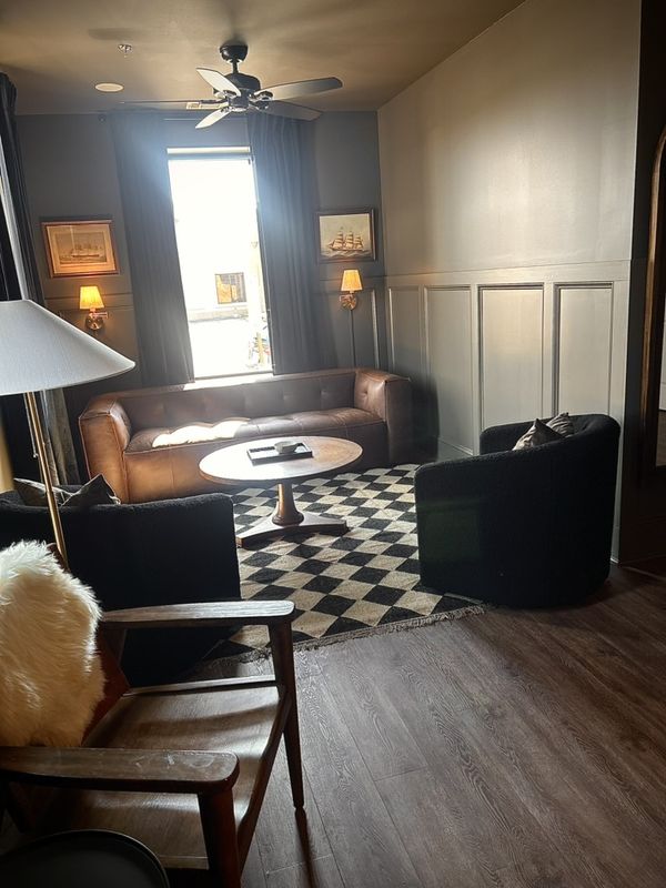 Lounge with leather sofa and checkered rug